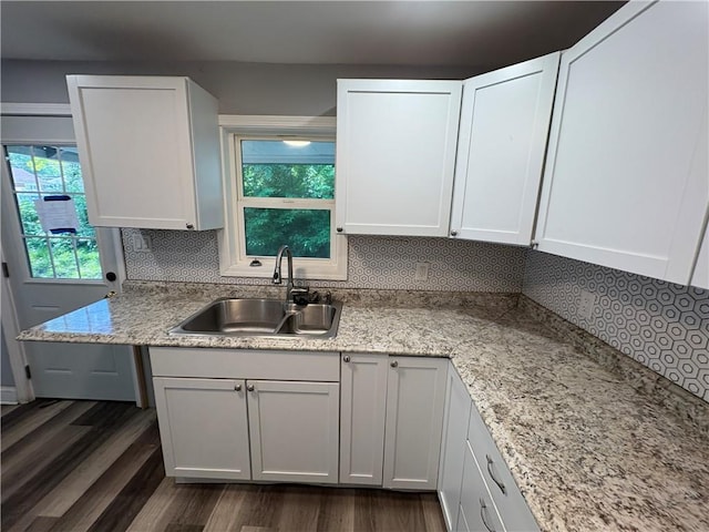 710 N Willis Ave, Independence, MO 64050 - kitchen featuring a sink, dark wood-type flooring, decorative backsplash, and healthy amount of natural light