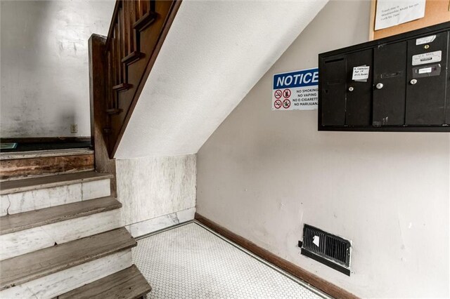 2713-2715 Benton Blvd, Kansas City, MO 64128 - staircase with vaulted ceiling and baseboards