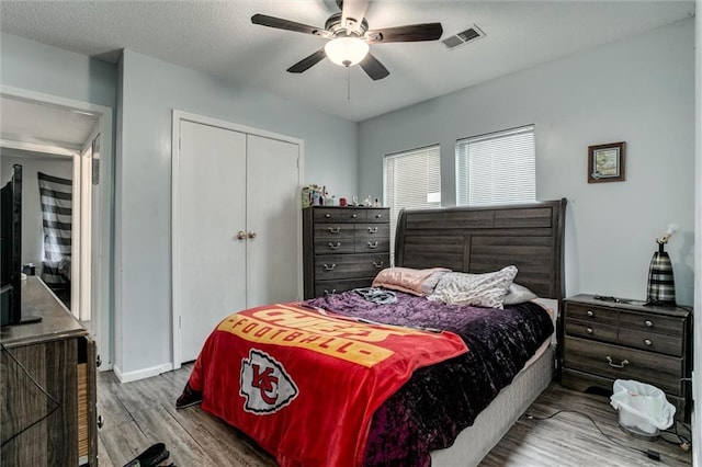 2713-2715 Benton Blvd, Kansas City, MO 64128 - bedroom with wood finished floors, a closet, and ceiling fan