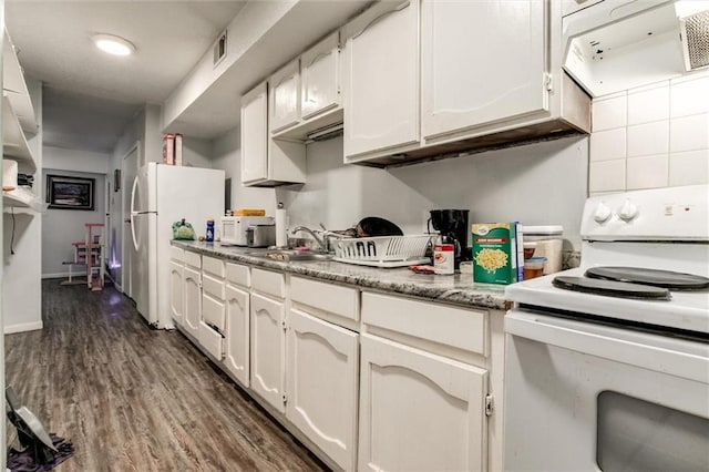 2713-2715 Benton Blvd, Kansas City, MO 64128 - kitchen featuring white appliances, a sink, white cabinets, dark wood-style floors, and exhaust hood