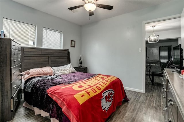 2713-2715 Benton Blvd, Kansas City, MO 64128 - bedroom featuring wood finished floors, baseboards, ceiling fan, and a chandelier