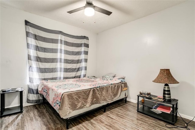 2713-2715 Benton Blvd, Kansas City, MO 64128 - bedroom featuring wood finished floors, baseboards, and a ceiling fan