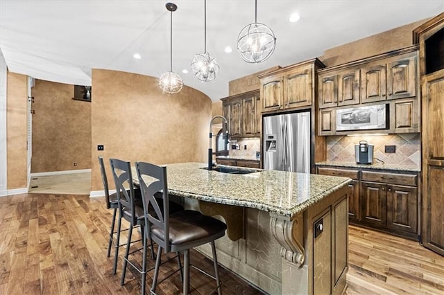 16249 Stearns St, Overland Park, KS 66221 - kitchen featuring stainless steel refrigerator with ice dispenser, a sink, white microwave, light wood-type flooring, and recessed lighting