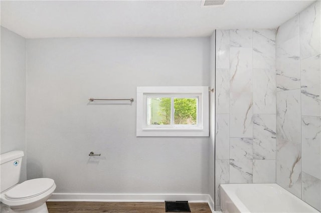 2206 E 30th St, Kansas City, MO 64109 - full bathroom featuring wood finished floors and bathtub / shower combination