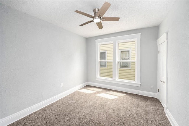 2206 E 30th St, Kansas City, MO 64109 - carpeted empty room featuring a textured wall, ceiling fan, and a textured ceiling