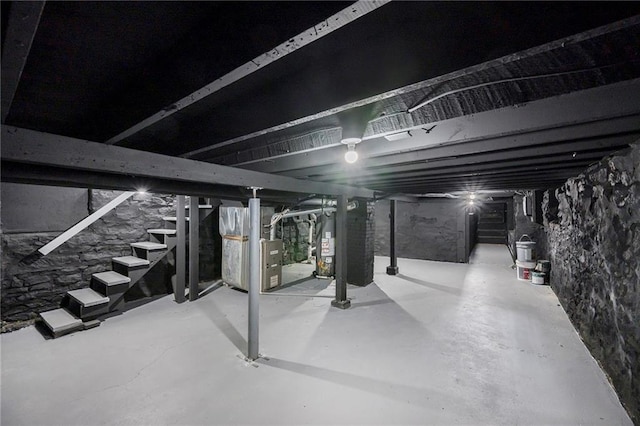 2206 E 30th St, Kansas City, MO 64109 - unfinished below grade area featuring stairs, gas water heater, and heating unit