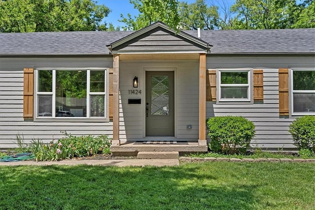 11424 W 68th Pl, Shawnee, KS 66203 - doorway to property with a lawn and a shingled roof