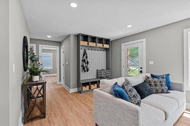 11424 W 68th Pl, Shawnee, KS 66203 - living area with light wood-style flooring, baseboards, healthy amount of natural light, a textured ceiling, and recessed lighting