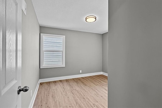 11424 W 68th Pl, Shawnee, KS 66203 - empty room with wood finished floors, baseboards, and a textured ceiling