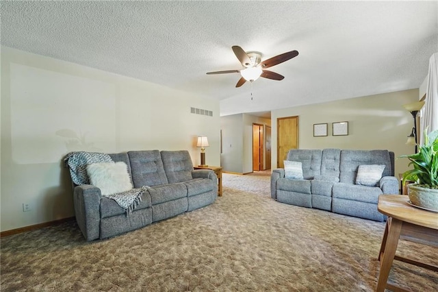 carpeted living room with a ceiling fan, a textured ceiling, and baseboards