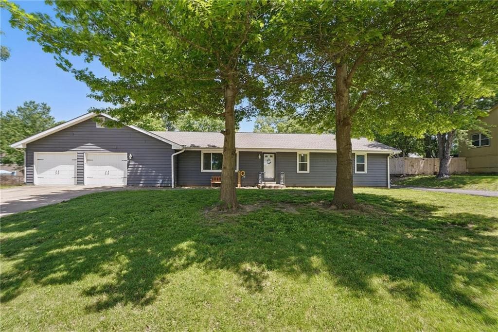 1151 S Bury St, Tonganoxie, KS 66086 - ranch-style home with an attached garage and driveway