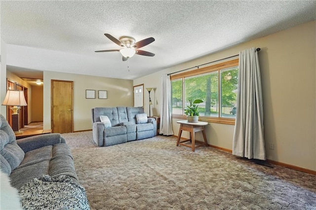 carpeted living area featuring ceiling fan, a textured ceiling, and baseboards