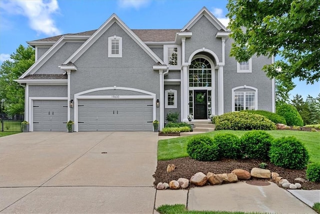 19600 W 98th St, Lenexa, KS 66220 - view of front of house with concrete driveway, stucco siding, and a garage