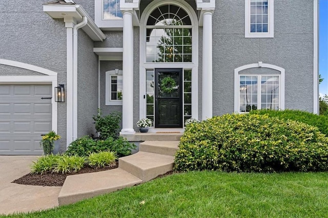 19600 W 98th St, Lenexa, KS 66220 - view of exterior entry with stucco siding and a garage