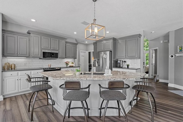 19600 W 98th St, Lenexa, KS 66220 - kitchen featuring stainless steel appliances, gray cabinetry, a sink, backsplash, and baseboards