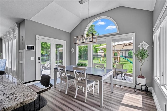 19600 W 98th St, Lenexa, KS 66220 - dining area featuring wood finished floors, vaulted ceiling, and a chandelier