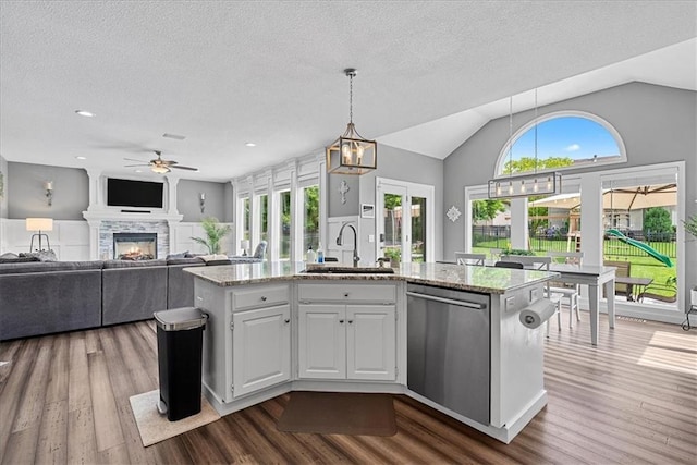 19600 W 98th St, Lenexa, KS 66220 - kitchen featuring dishwasher, a sink, ceiling fan, a kitchen island with sink, and light stone countertops