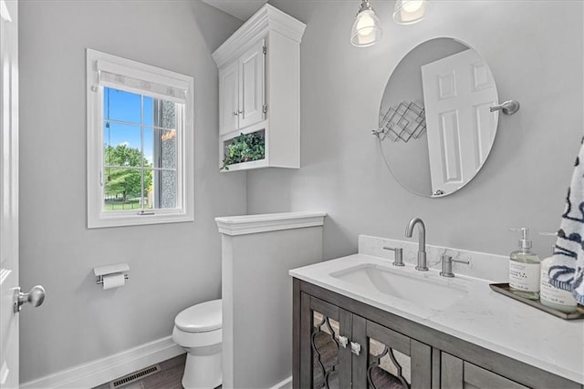 19600 W 98th St, Lenexa, KS 66220 - bathroom featuring toilet, vanity, baseboards, and wood finished floors