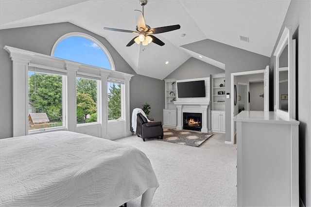 19600 W 98th St, Lenexa, KS 66220 - bedroom featuring vaulted ceiling, light colored carpet, a lit fireplace, and ceiling fan