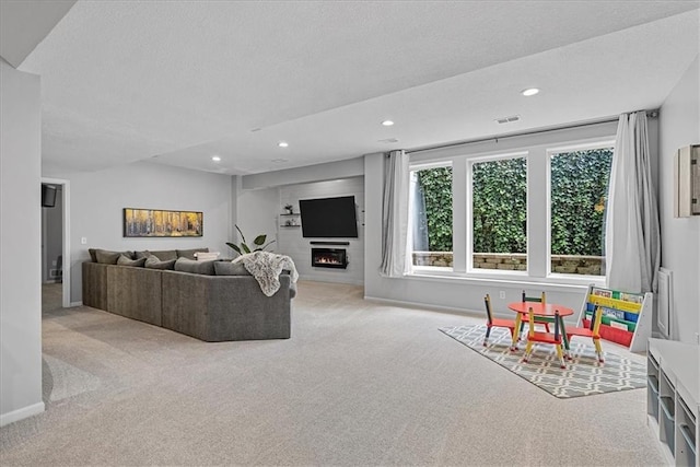 19600 W 98th St, Lenexa, KS 66220 - living room featuring carpet floors, a warm lit fireplace, a textured ceiling, recessed lighting, and baseboards