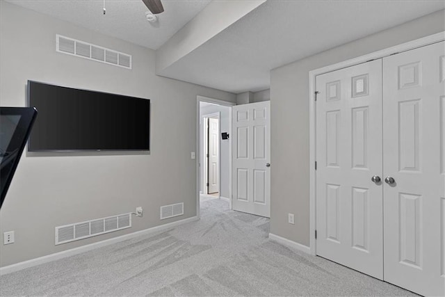 19600 W 98th St, Lenexa, KS 66220 - unfurnished bedroom featuring carpet flooring, a closet, baseboards, and a ceiling fan