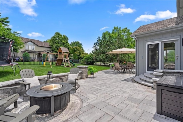 19600 W 98th St, Lenexa, KS 66220 - view of patio / terrace featuring a fire pit, a trampoline, a playground, and outdoor dining space