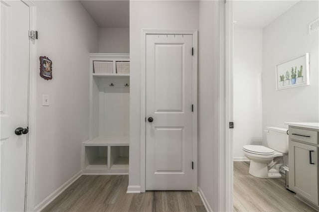 mudroom with light wood-style flooring and baseboards