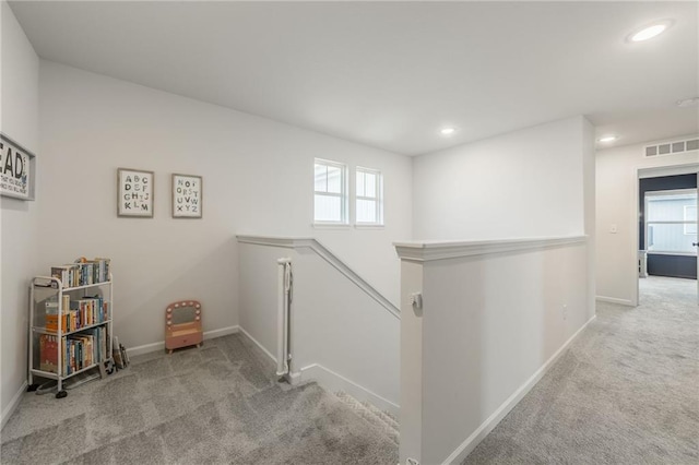 staircase featuring carpet, healthy amount of natural light, baseboards, and recessed lighting