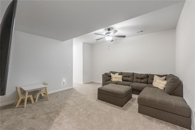 living area featuring carpet flooring, a ceiling fan, and baseboards