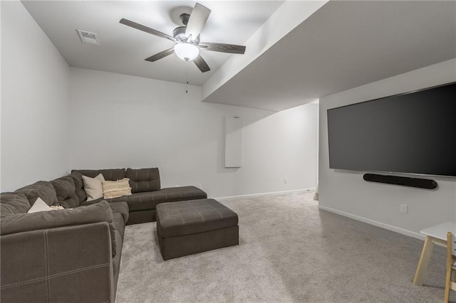 carpeted living room with a ceiling fan and baseboards