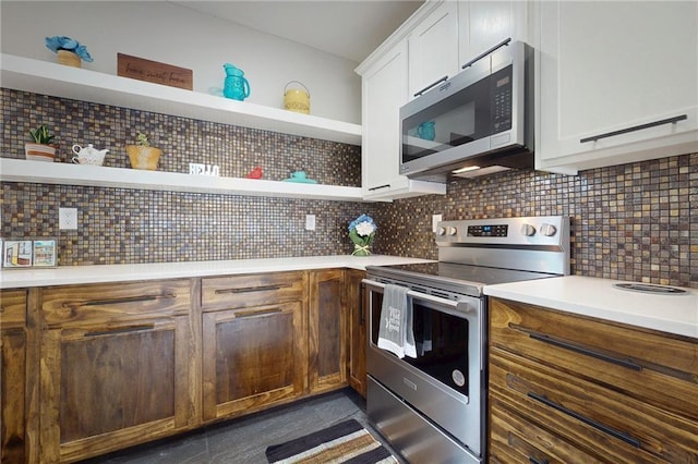 kitchen with stainless steel appliances, open shelves, white cabinets, and light countertops
