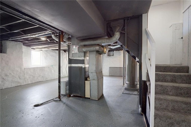 basement featuring stairway and heating unit