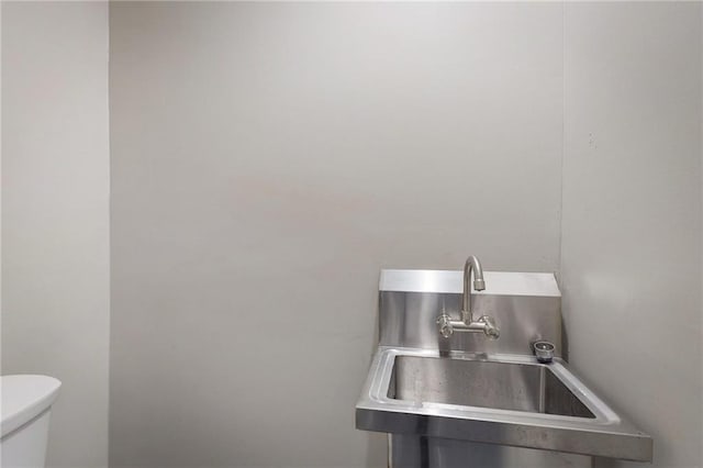 half bath with a sink and toilet
