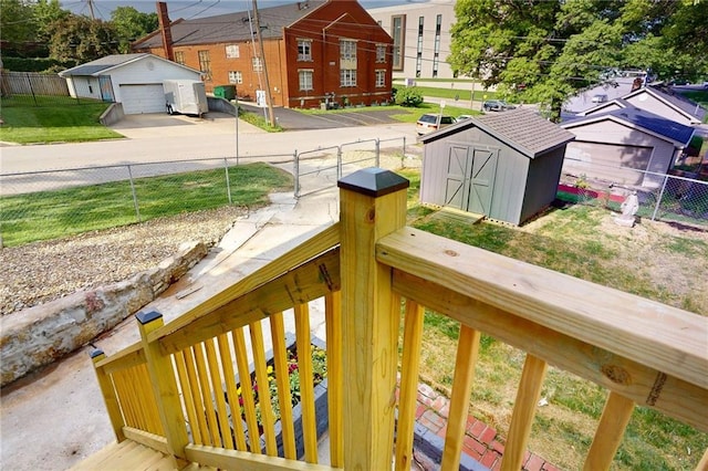 view of yard featuring an outdoor structure, a detached garage, a shed, and concrete driveway