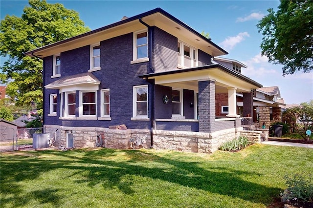 view of front facade with a front lawn, central AC, brick siding, and a porch