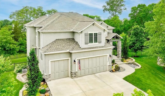 17817 Grandview St, Overland Park, KS 66013 - view of front of property with stucco siding, concrete driveway, stone siding, and a garage