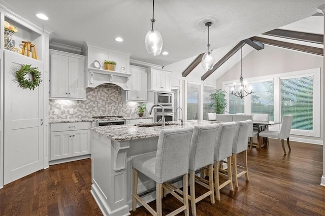 17817 Grandview St, Overland Park, KS 66013 - kitchen featuring stainless steel microwave, a sink, a kitchen breakfast bar, decorative backsplash, and light stone counters