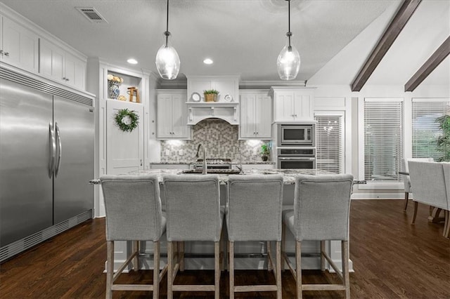 17817 Grandview St, Overland Park, KS 66013 - kitchen with built in appliances, tasteful backsplash, hanging light fixtures, an island with sink, and recessed lighting