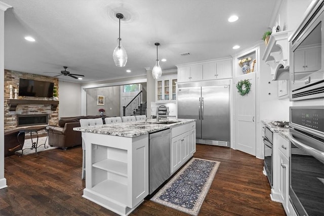 17817 Grandview St, Overland Park, KS 66013 - kitchen featuring built in appliances, a ceiling fan, open shelves, a sink, and a fireplace