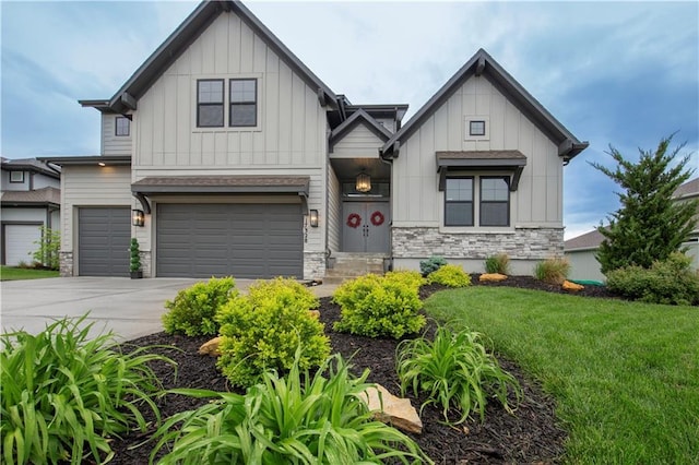 17328 Richards St, Overland Park, KS 66221 - view of front of home with board and batten siding, stone siding, concrete driveway, and a front yard
