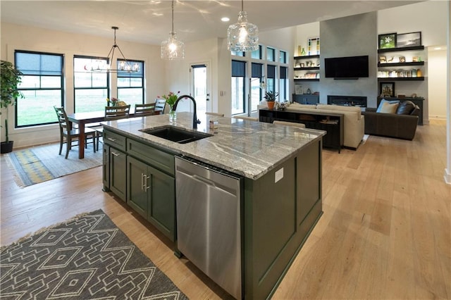 17328 Richards St, Overland Park, KS 66221 - kitchen featuring a sink, dishwasher, a kitchen island with sink, light wood-style flooring, and a fireplace