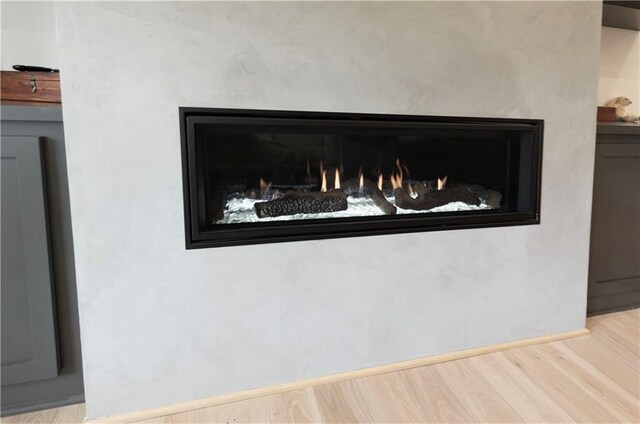 17328 Richards St, Overland Park, KS 66221 - detailed view of wood finished floors, baseboards, and a fireplace
