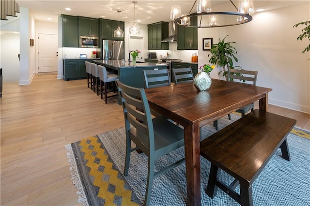 17328 Richards St, Overland Park, KS 66221 - dining area with baseboards, light wood finished floors, a chandelier, and recessed lighting