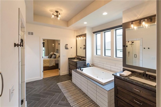 17328 Richards St, Overland Park, KS 66221 - ensuite bathroom featuring a stall shower, a tub with jets, two vanities, baseboards, and recessed lighting