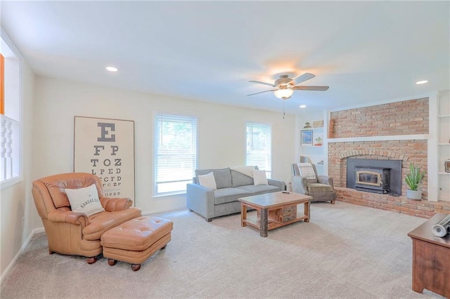 living room featuring carpet, a ceiling fan, baseboards, recessed lighting, and a brick fireplace