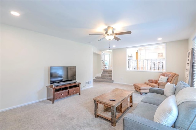 living room with stairway, light carpet, ceiling fan, recessed lighting, and baseboards