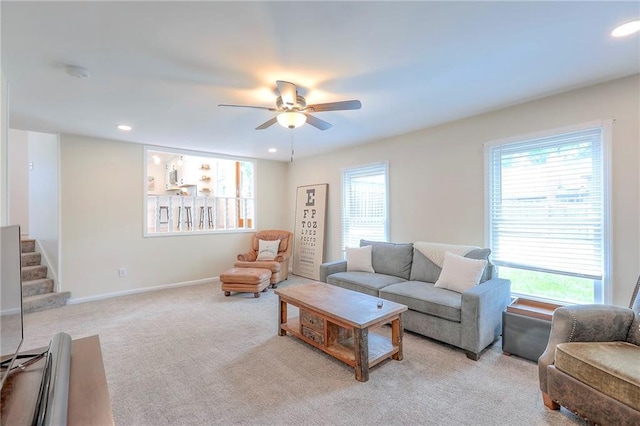 carpeted living room featuring a ceiling fan, recessed lighting, baseboards, and stairway