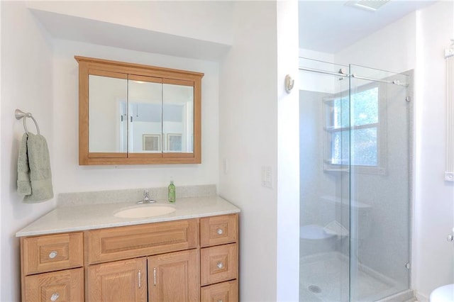 full bath featuring a stall shower and vanity