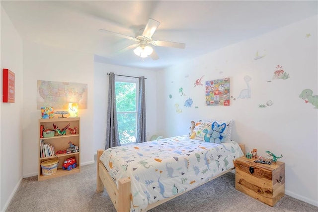bedroom featuring light colored carpet, baseboards, and ceiling fan