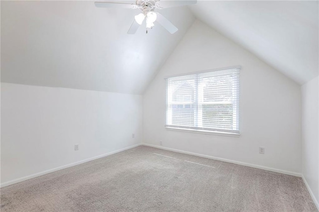 additional living space with carpet, lofted ceiling, a ceiling fan, and baseboards